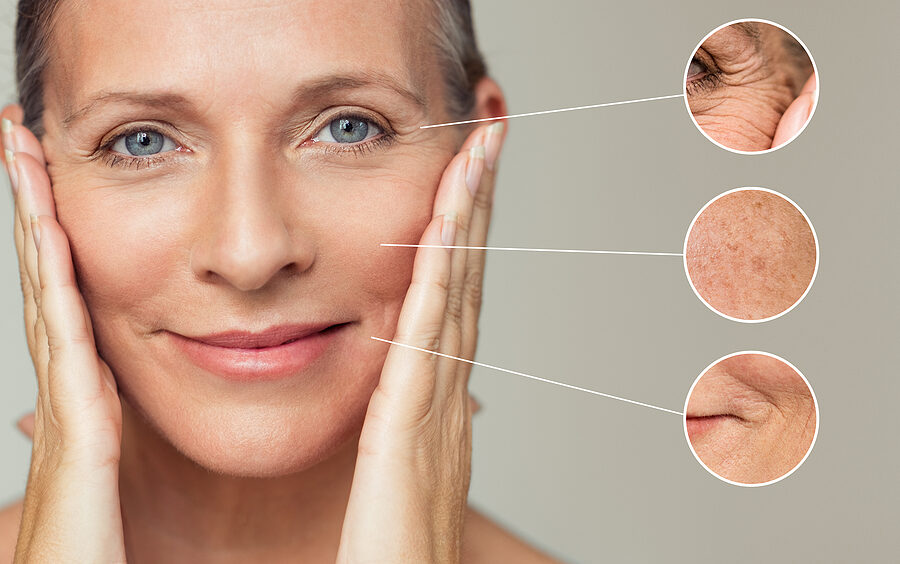 Close ups of wrinkles and skin imperfection on the face of a beautiful senior woman touching her perfect skin after an anti-aging treatment.